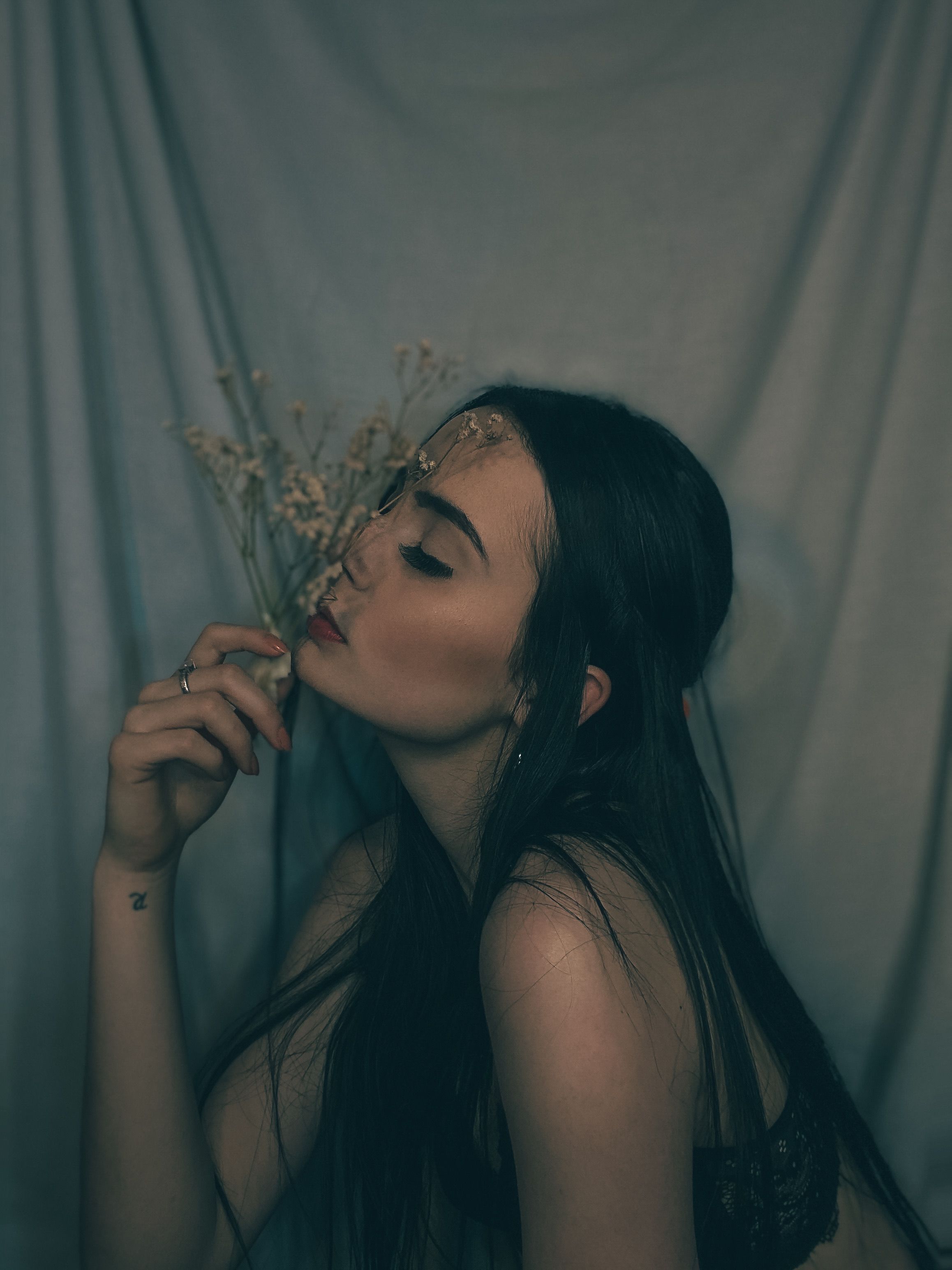 A woman with long hair and a flower in her mouth · Free Stock Photo