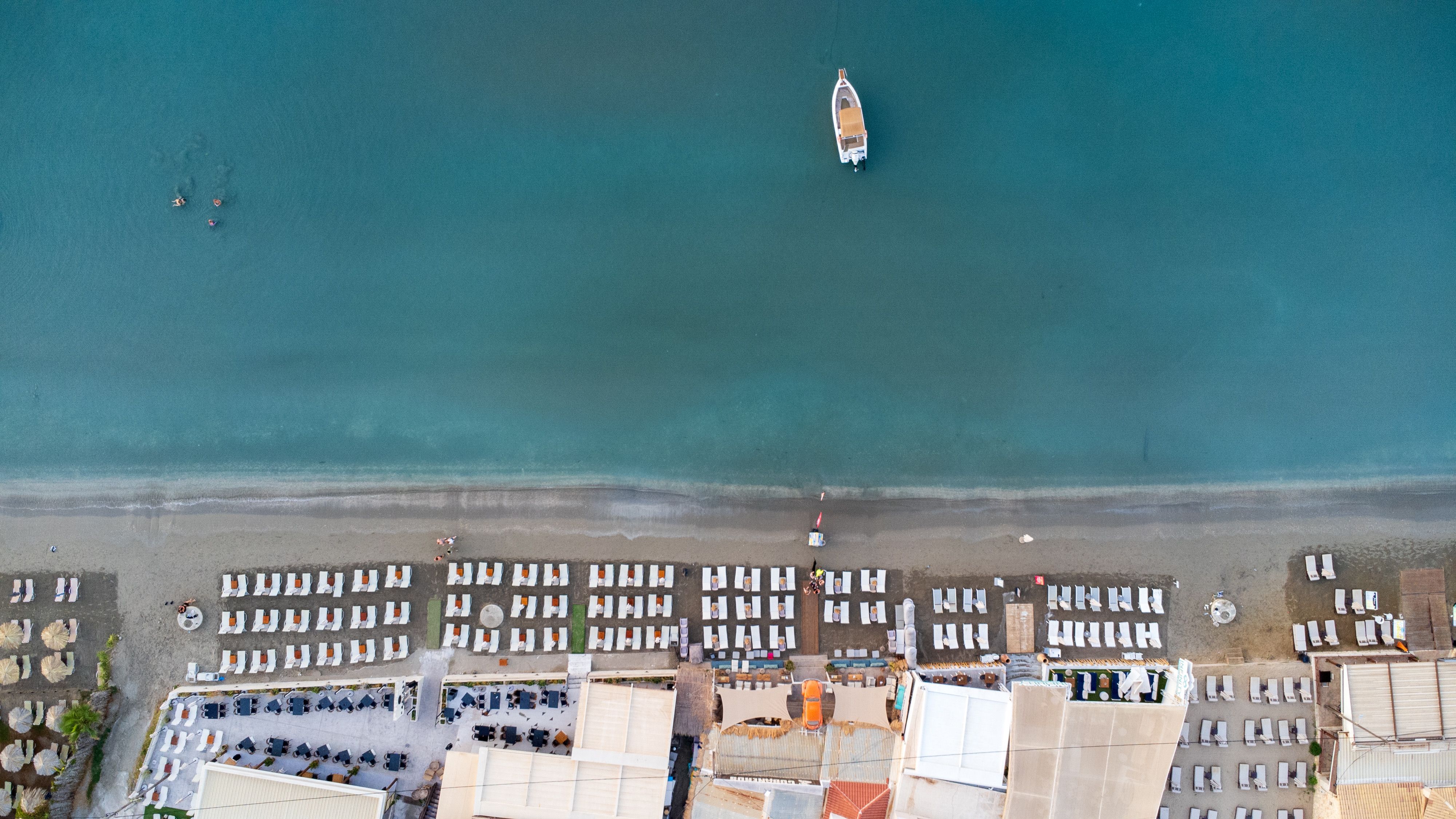 Aerial view of a beach and a boat in the water · Free Stock Photo