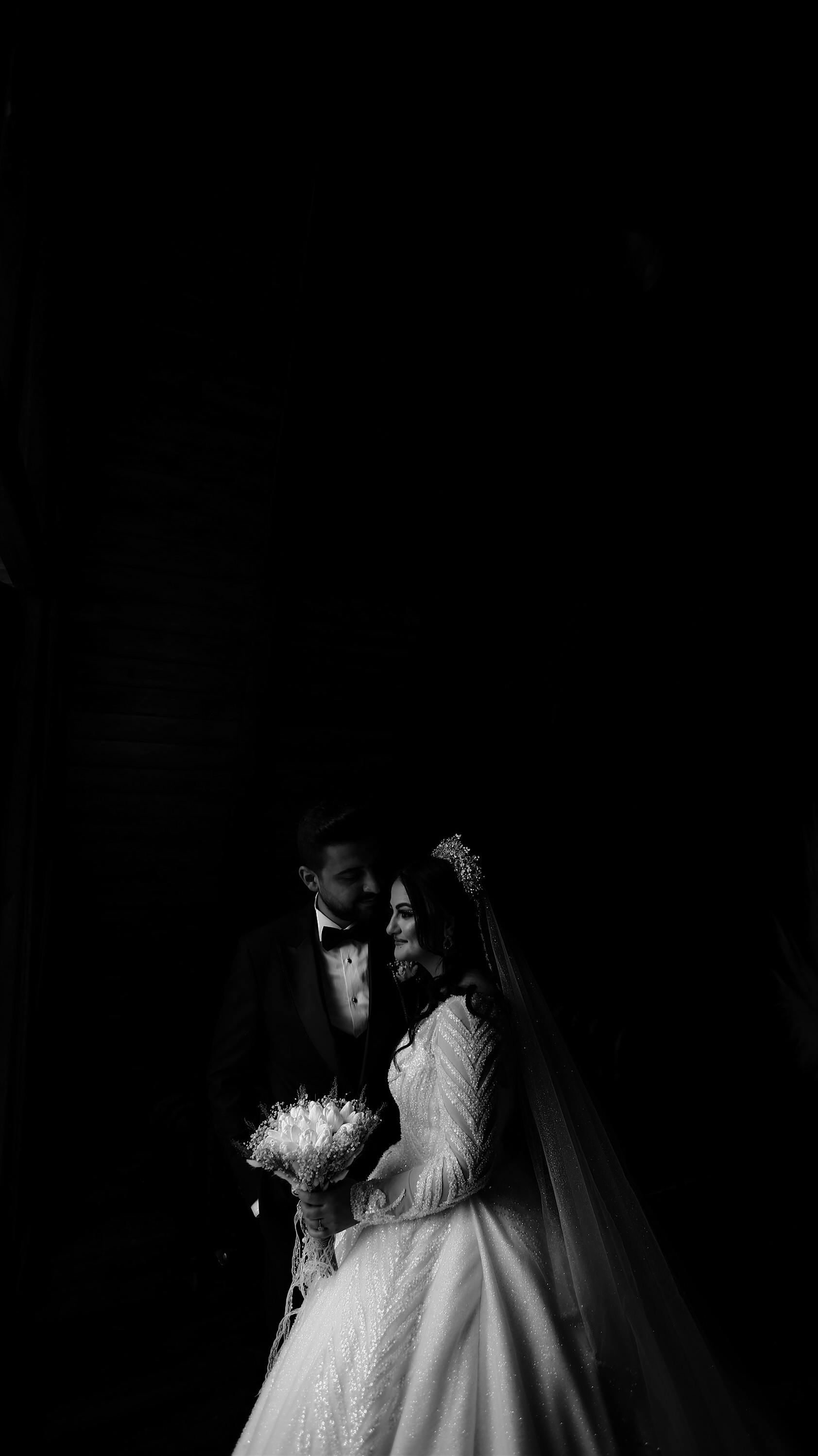 a black and white photo of a bride and groom