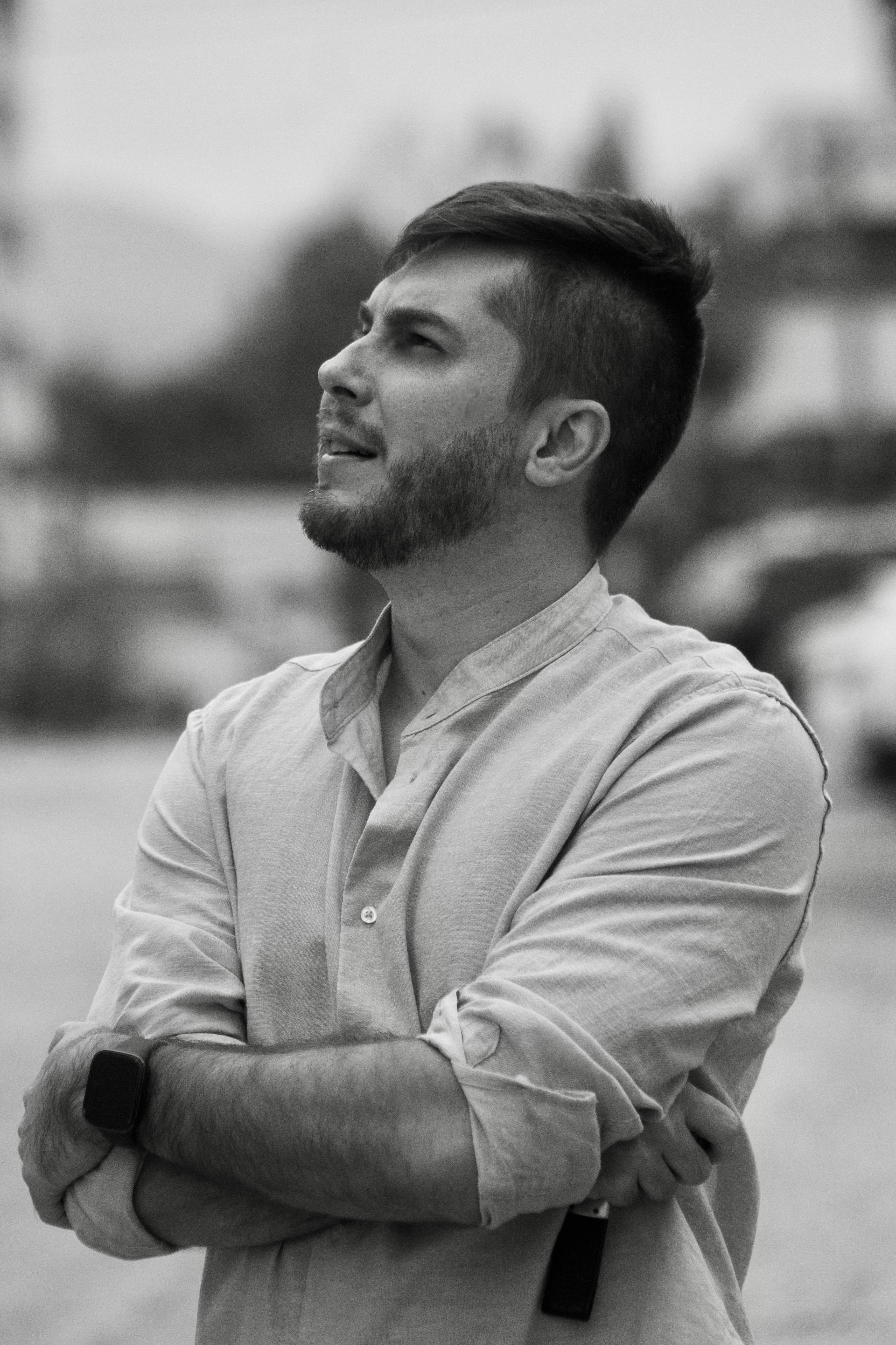 Profile portrait of a pensive man outdoors in Blumenau, Brazil, capturing a thoughtful moment.