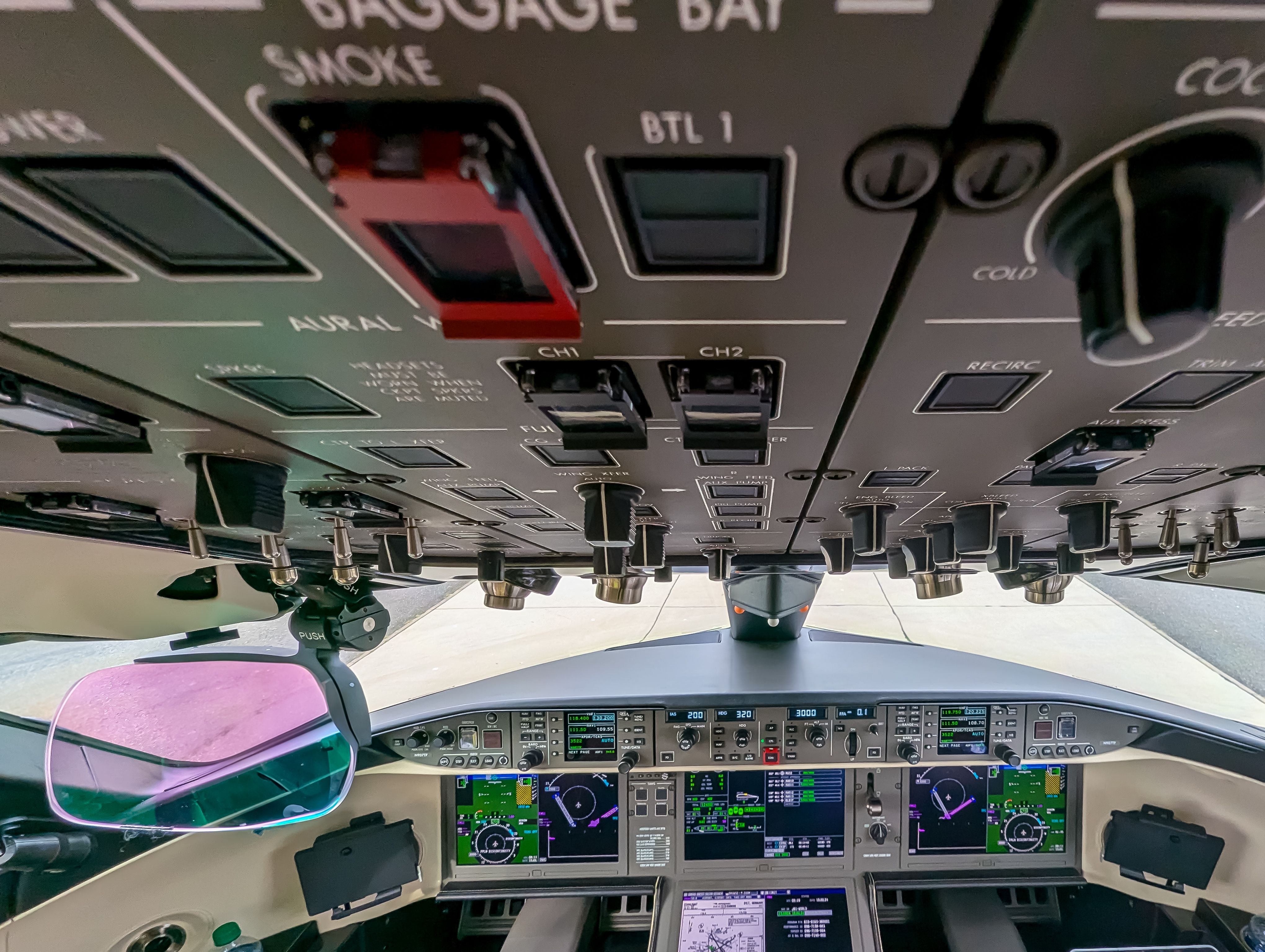 View of a high-tech cockpit with advanced avionics and control panels in an aircraft.