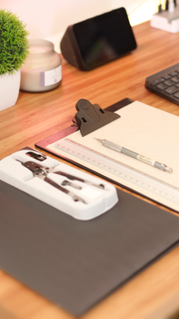 Stylish workspace featuring drawing tools, a tablet, and minimal decor for productivity.