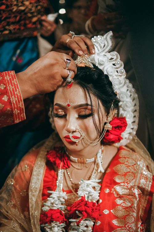 Free Beautiful South Asian bride adorned in traditional wedding attire during a cultural ceremony. Stock Photo