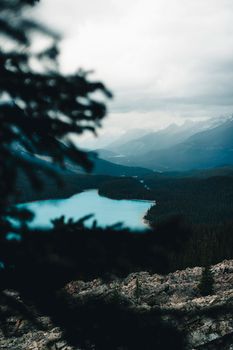 Vibrant lake and mountain scenery in Banff National Park, Canada, under moody skies.