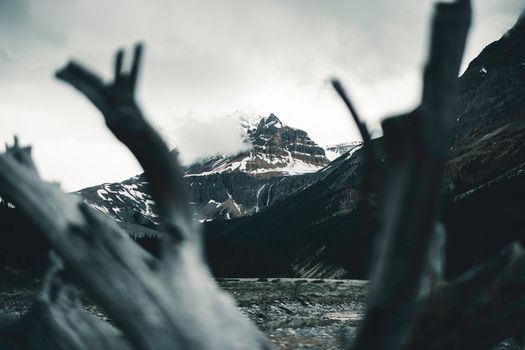 Captivating view of snow-capped mountains shrouded in clouds in Banff National Park, Canada.