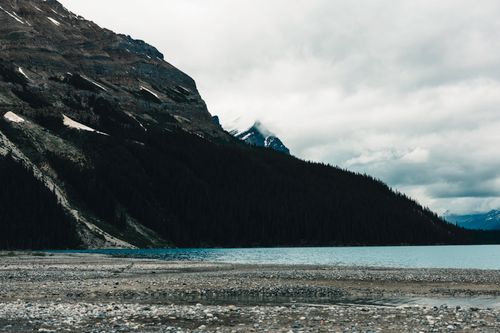 Free Breathtaking view of a serene lake framed by rugged mountains in Banff National Park, Canada. Stock Photo