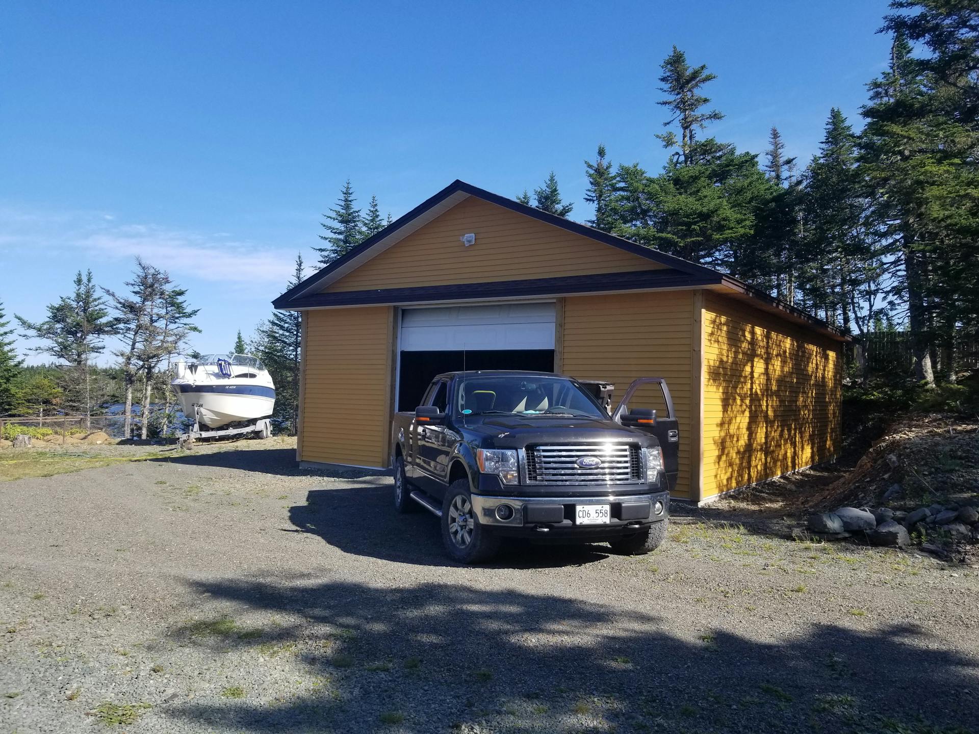 A truck is parked in front of a garage