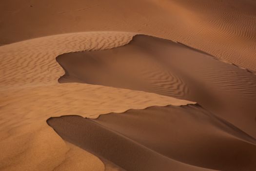 Captivating view of the golden sand dunes in the Sahara Desert, Algeria, showcasing nature's beauty.