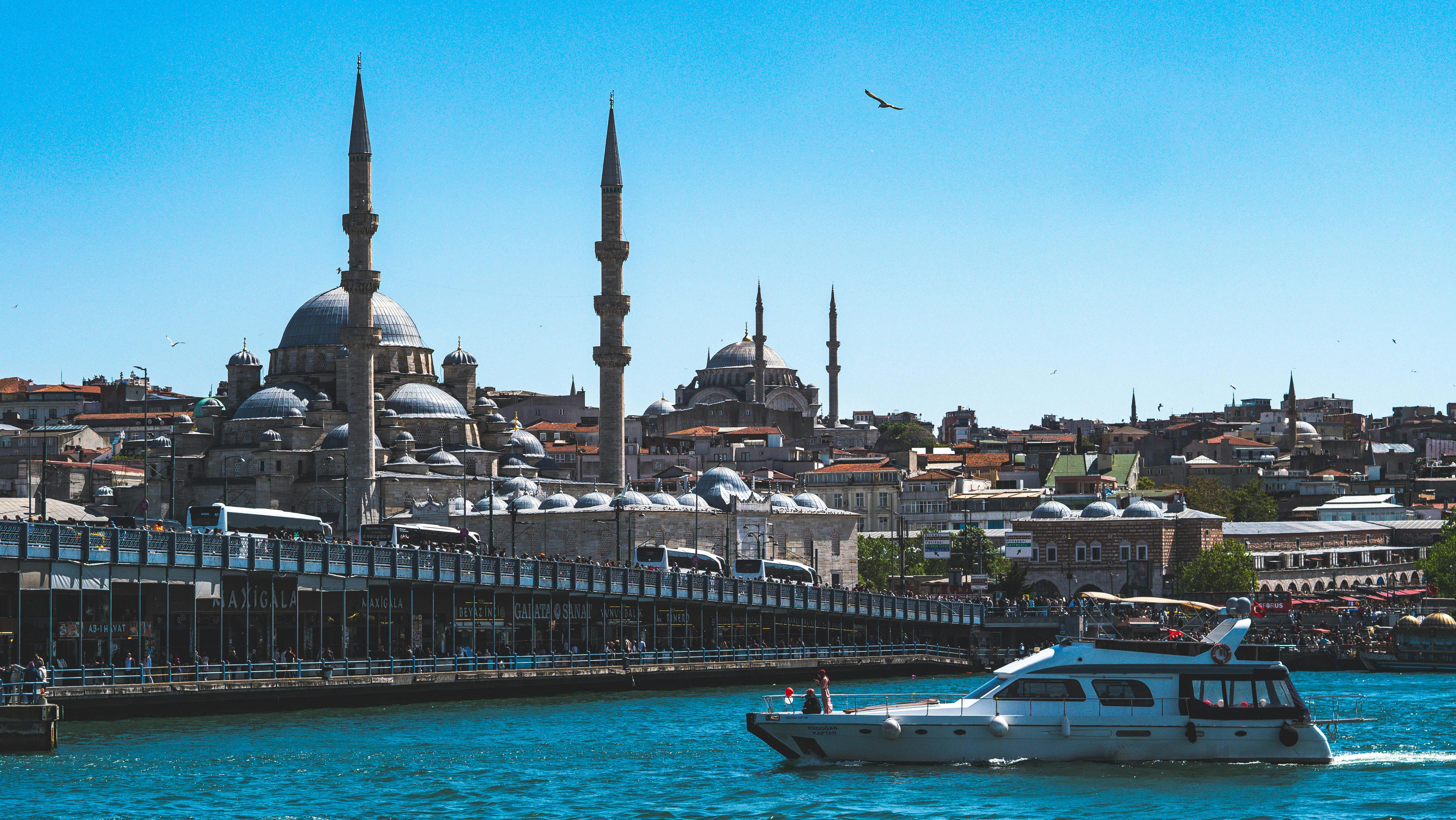 a boat traveling through the water near a mosque