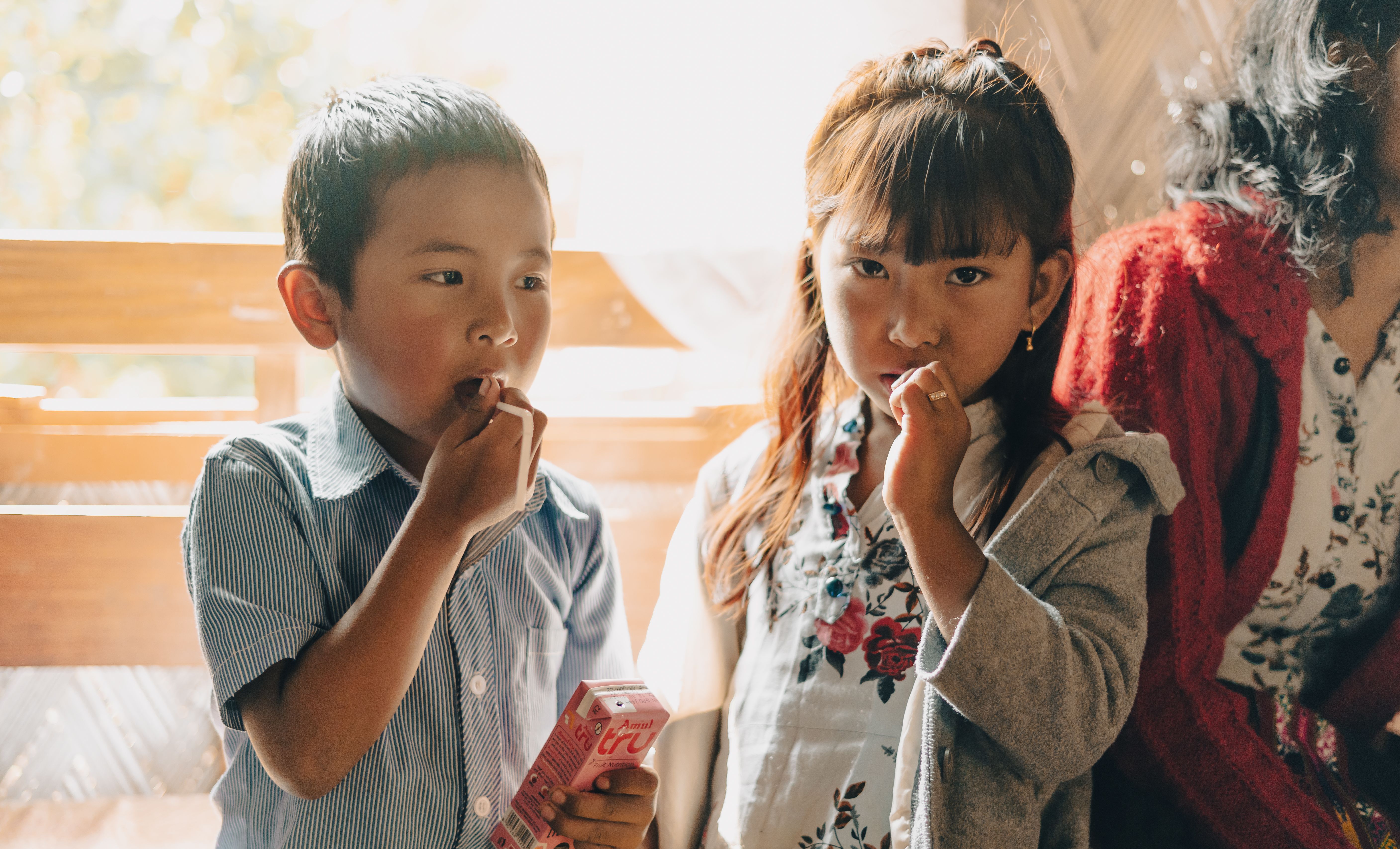 Two children and one adult eating candy · Free Stock Photo