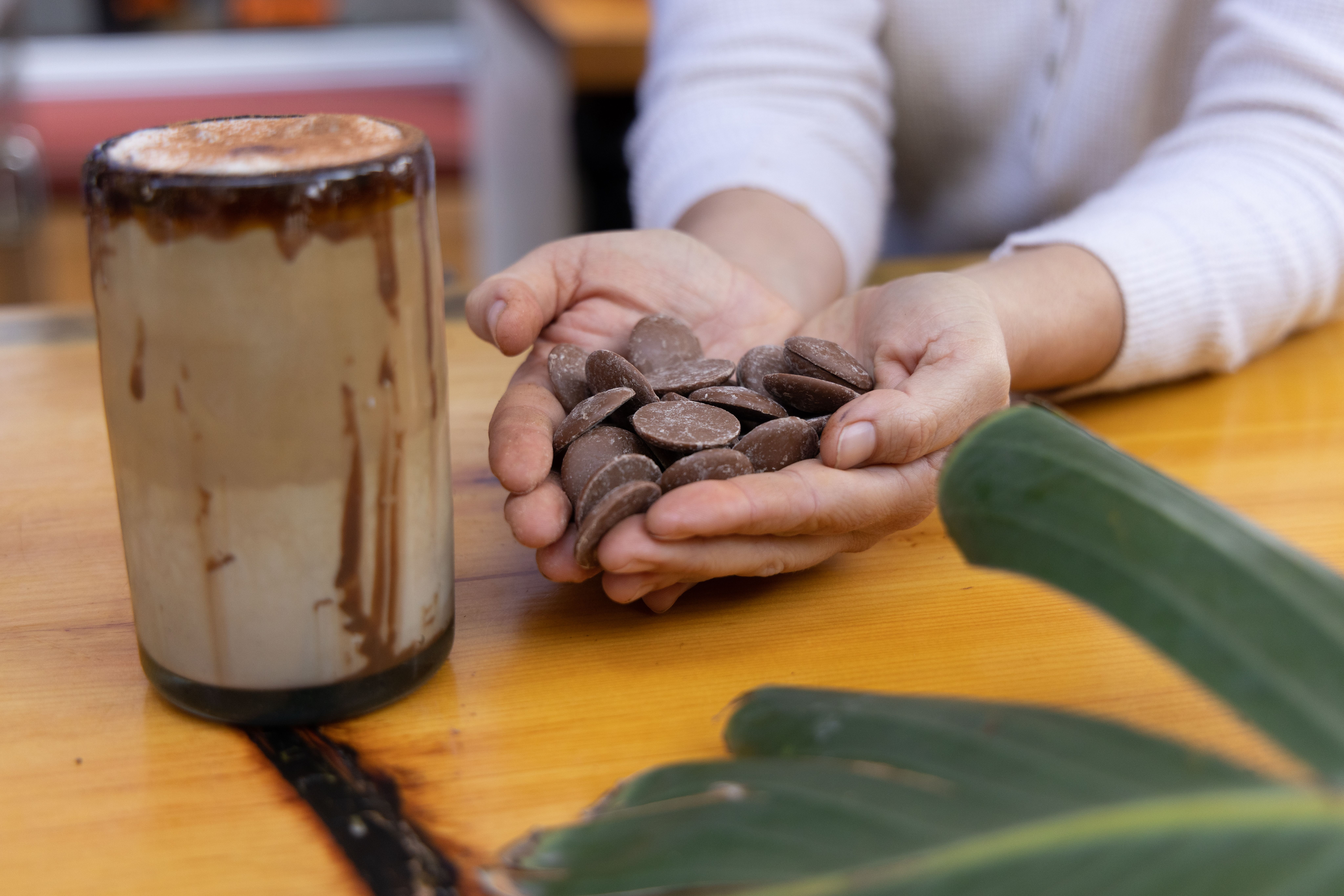 Dark creamy cacao and almond nut milk in a glass bottle