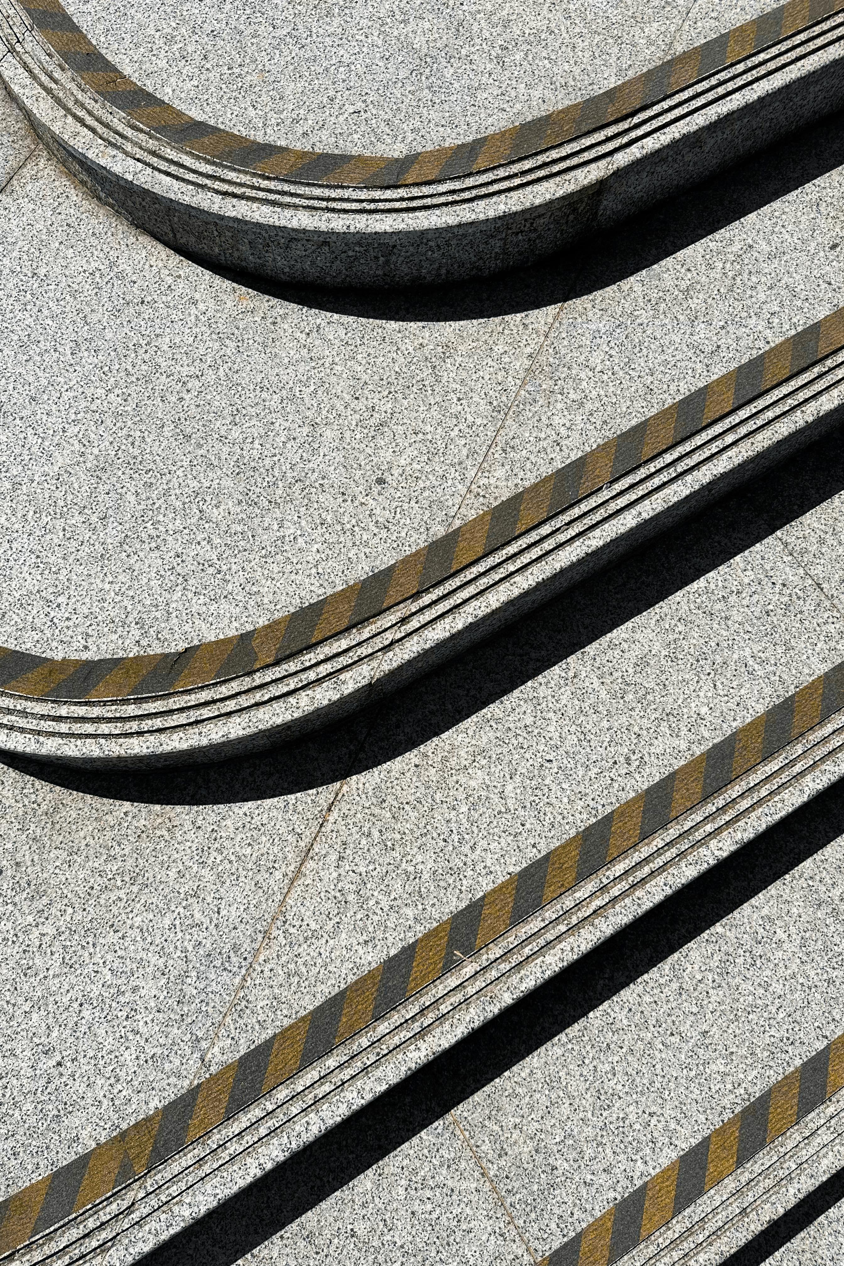 Modern abstract view of concrete stairs with striped safety pattern.