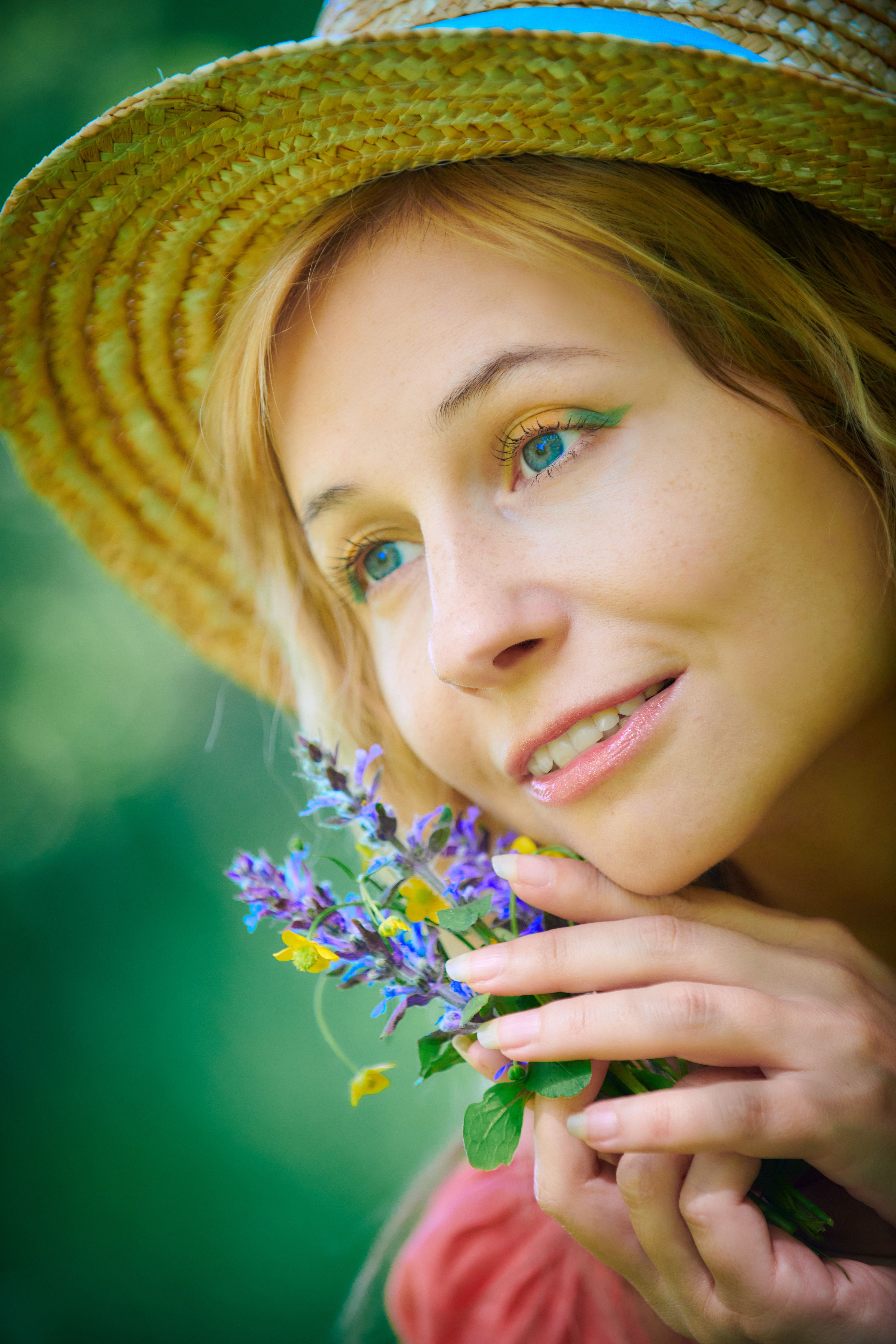 A woman in a straw hat holding a flower · Free Stock Photo