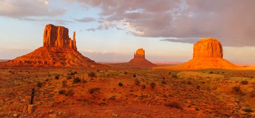 Free Breathtaking view of Monument Valley's sandstone buttes during a golden sunset. Stock Photo