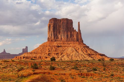 Free Monument Valley's iconic buttes in Moab, Utah, captured under a clear sky, showcasing stunning natural rock formations. Stock Photo