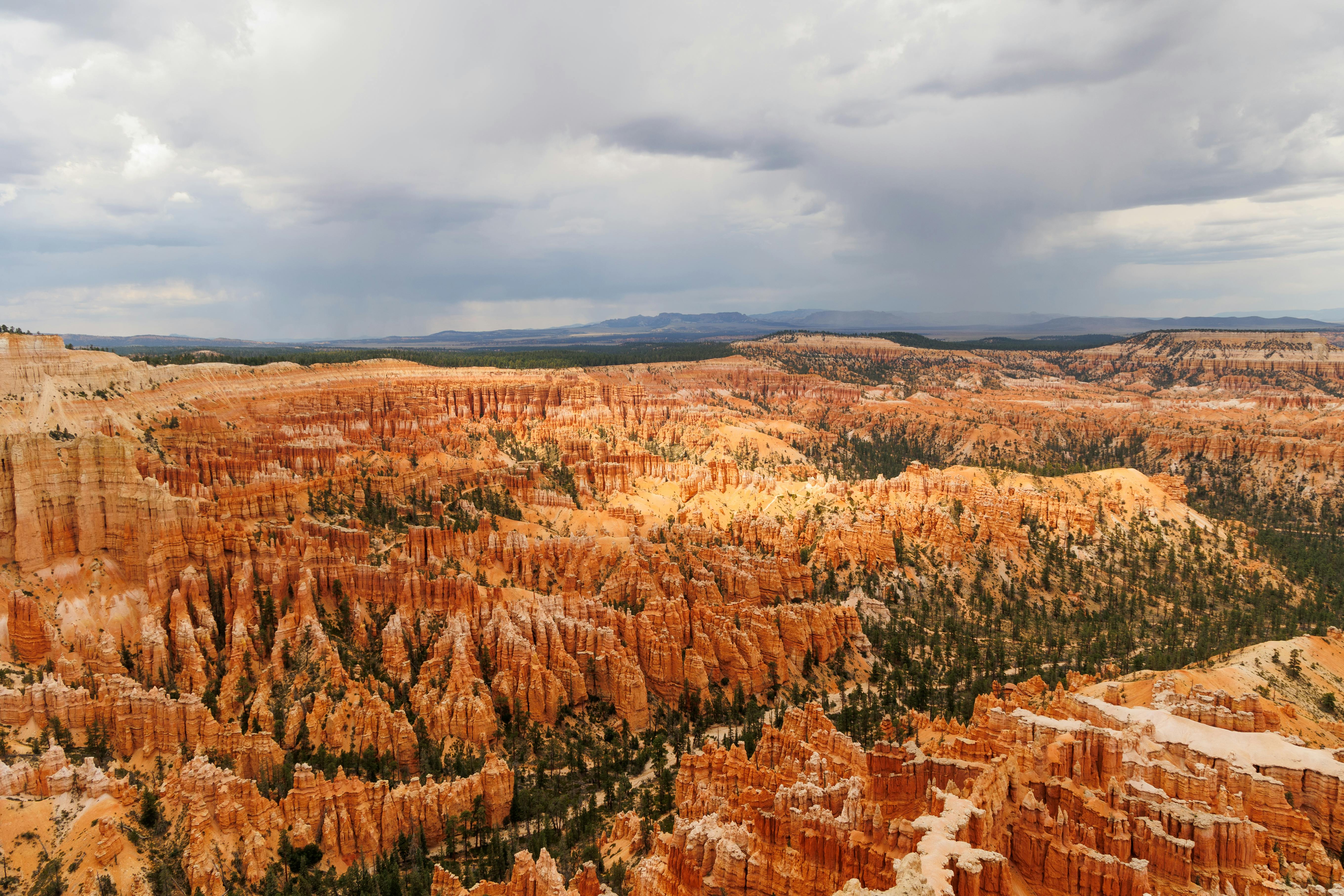 Free Explore the stunning hoodoo formations of Bryce Canyon under a dramatic overcast sky. Stock Photo