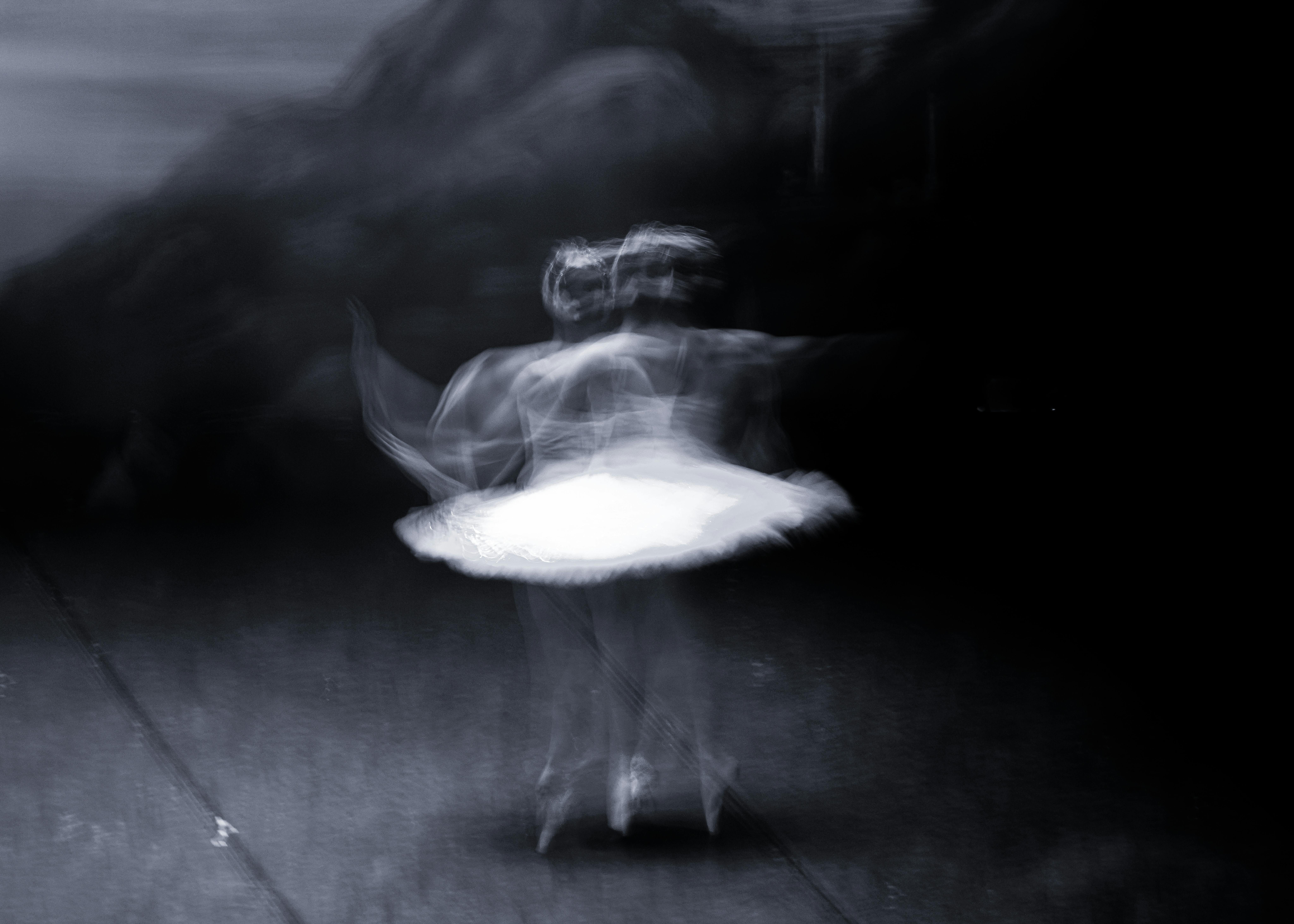 Abstract black and white photograph of a ballerina in motion, capturing fluidity and grace.