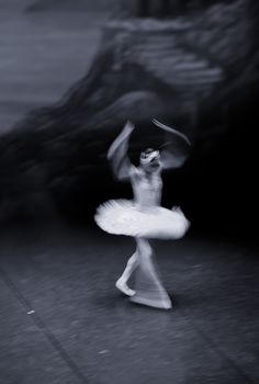 A dynamic black and white photo of a ballet dancer in motion, capturing elegance and grace.