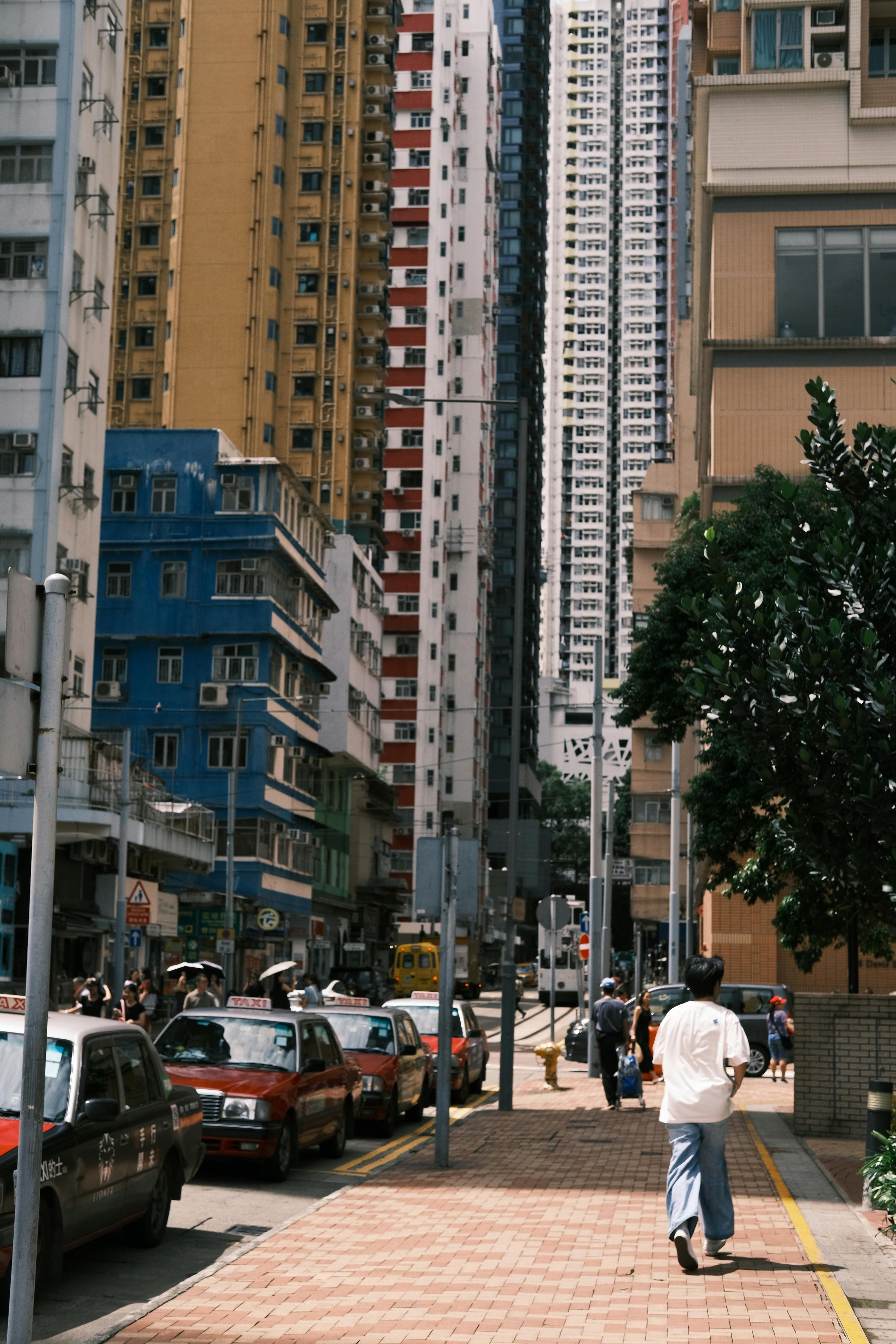 Urban street view with towering buildings and busy city life.