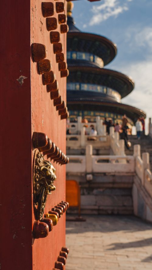 Free Detailed view of a traditional gate with the Temple of Heaven in Beijing, China in the background. Stock Photo