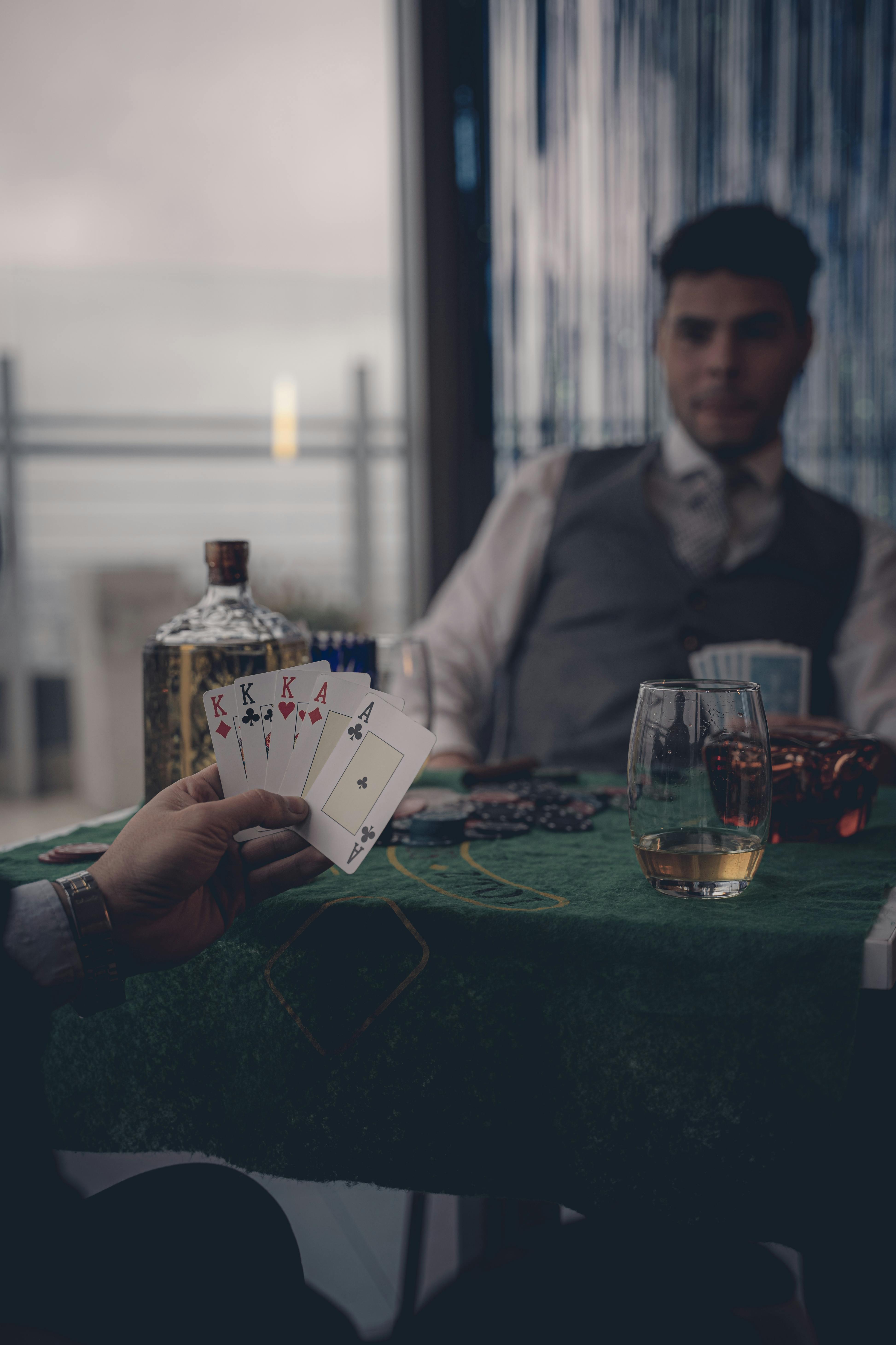 a man playing cards at a table with a woman