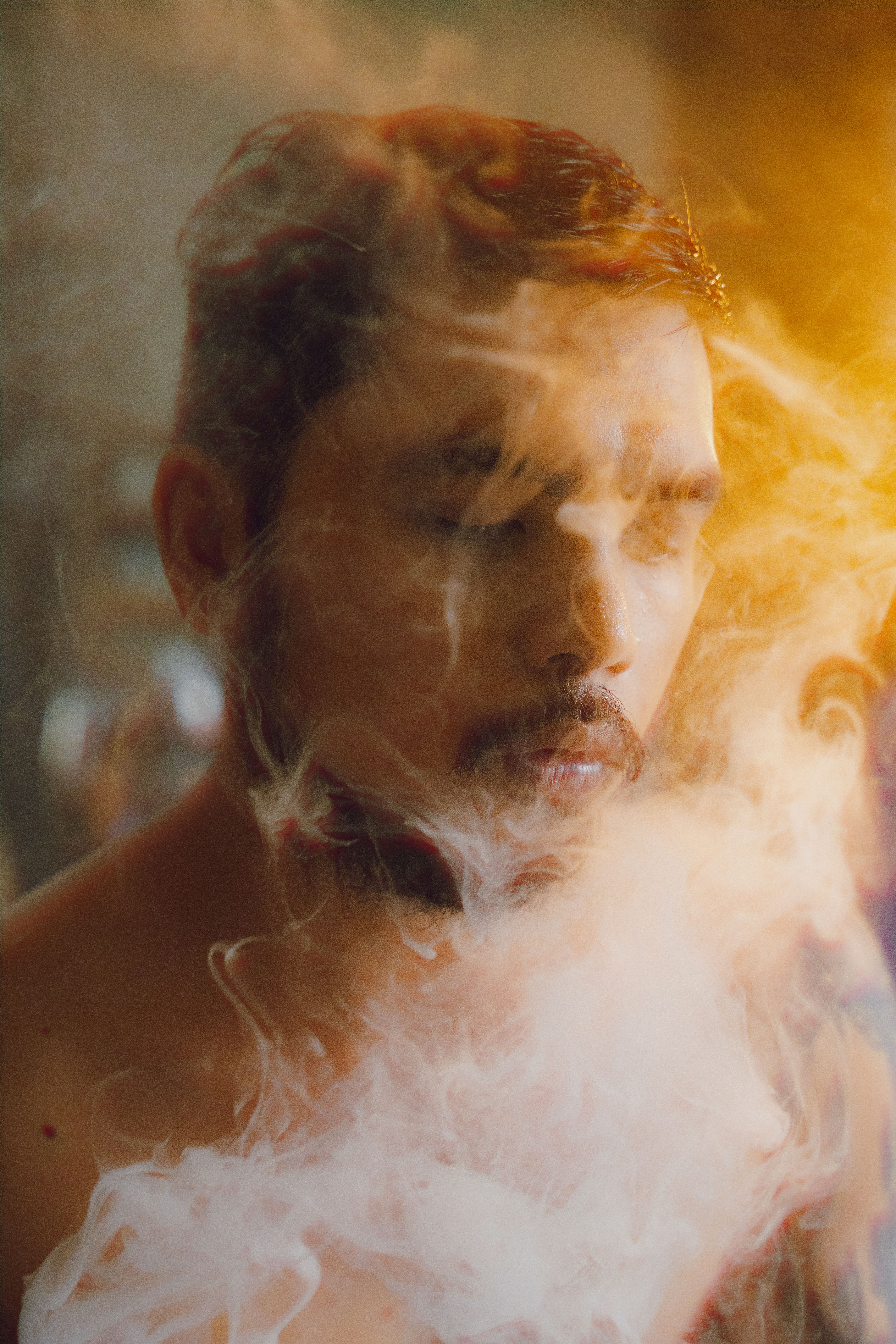 A man with smoke coming out of his mouth · Free Stock Photo