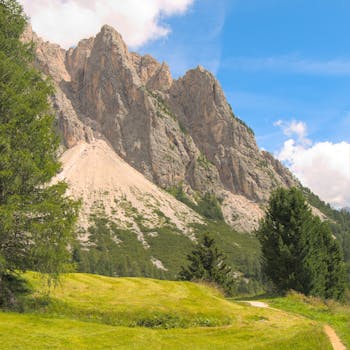 Stunning view of a mountain in Santa Cristina Valgardena, Italy, featuring lush greenery and clear skies.