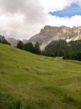 Breathtaking summer landscape of Dolomites with lush green meadows and majestic mountains.