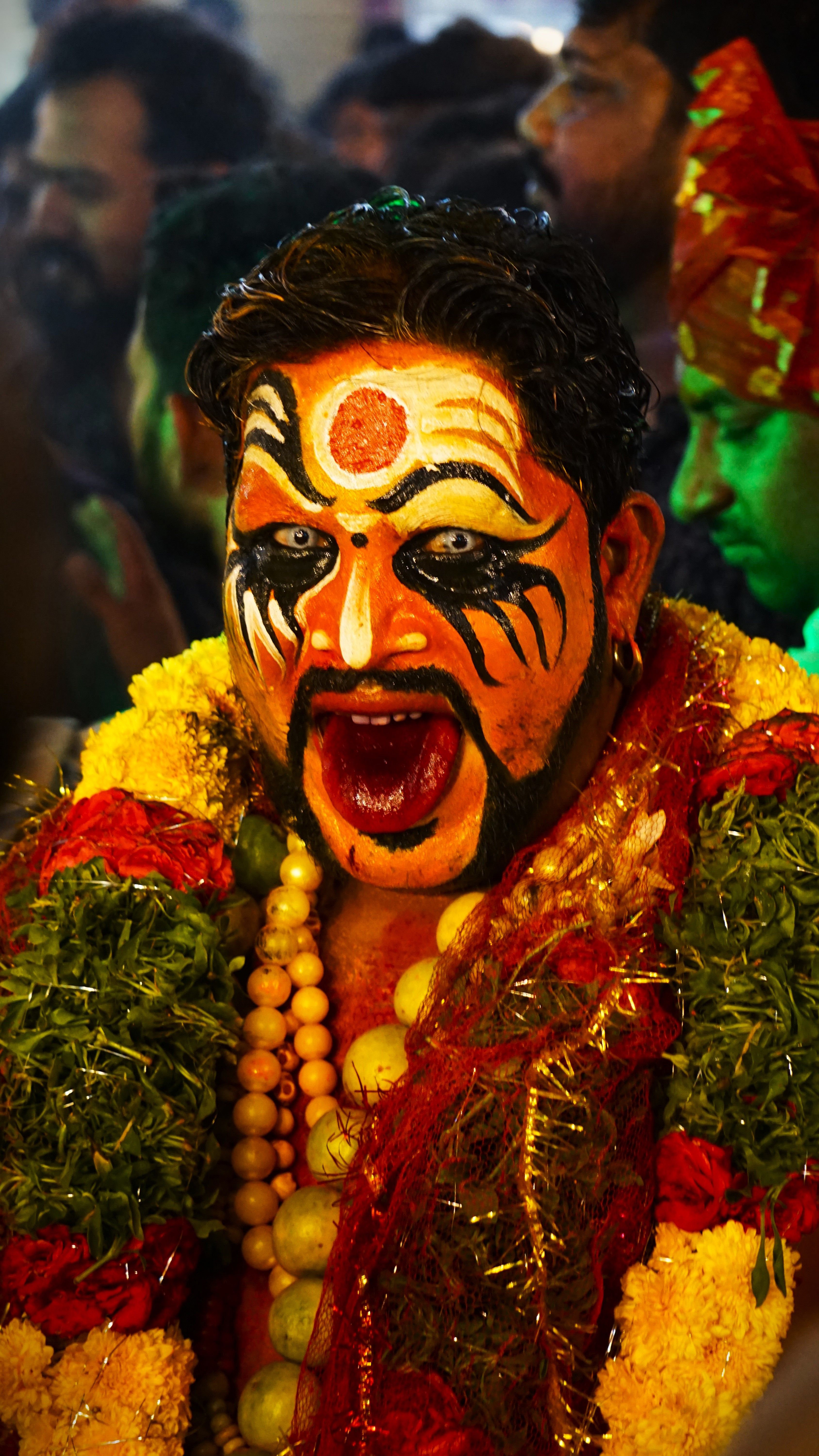 Colorful face paint and costume at a Hindu festival in Hyderabad, India.