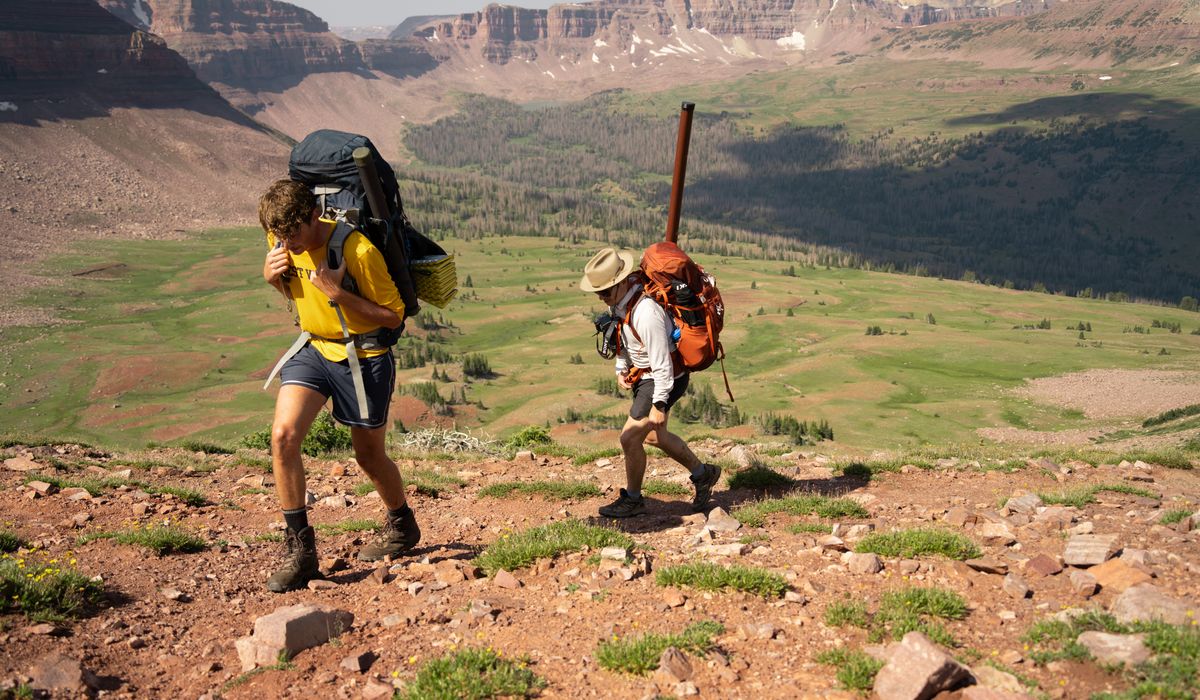 Travelers with backpacks on a trail
