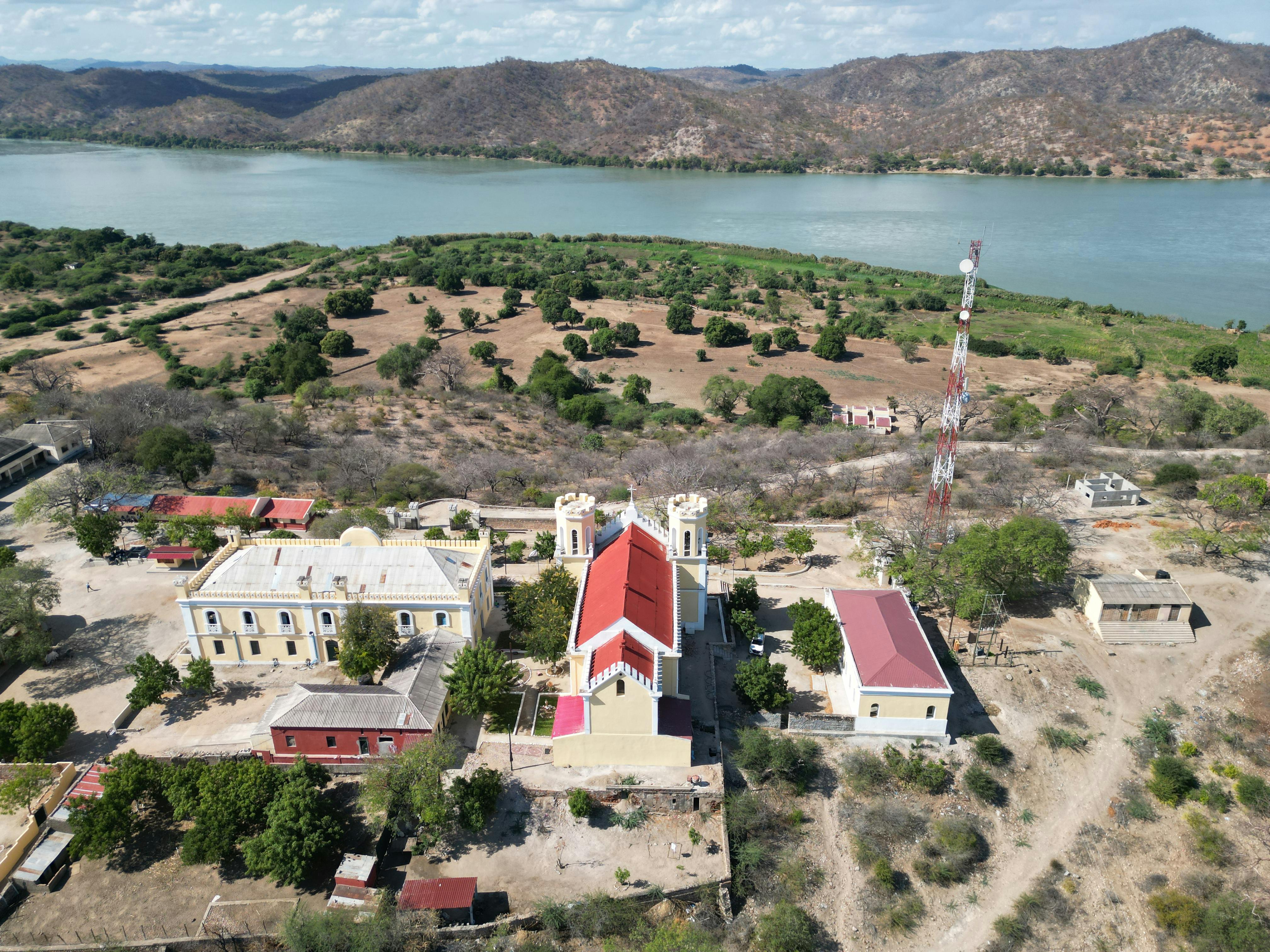 An aerial view of a church and a lake