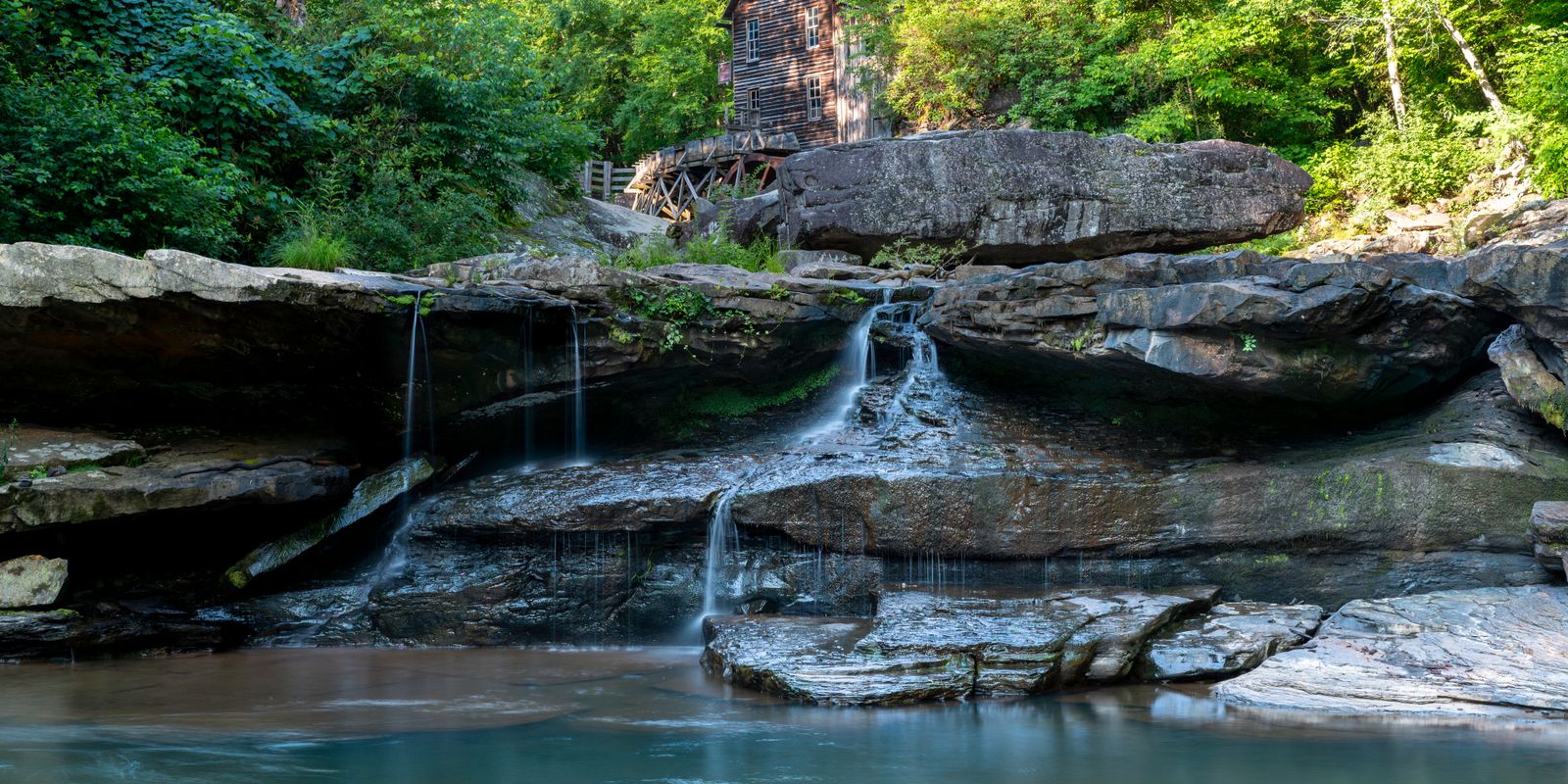 The Glade Creek Grist Mill with its waterfall surrounded by lush greenery in West Virginia
