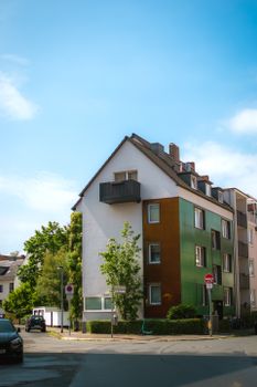 Modern apartment building with colorful facade on a sunny day.