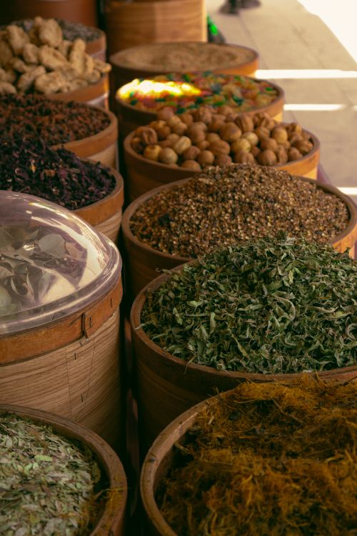 Free Explore a colorful assortment of natural spices and herbs in a traditional market setting. Stock Photo