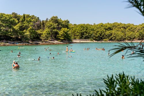 Free People enjoying a sunny day at the clear waters of Supetar, Croatia. Stock Photo