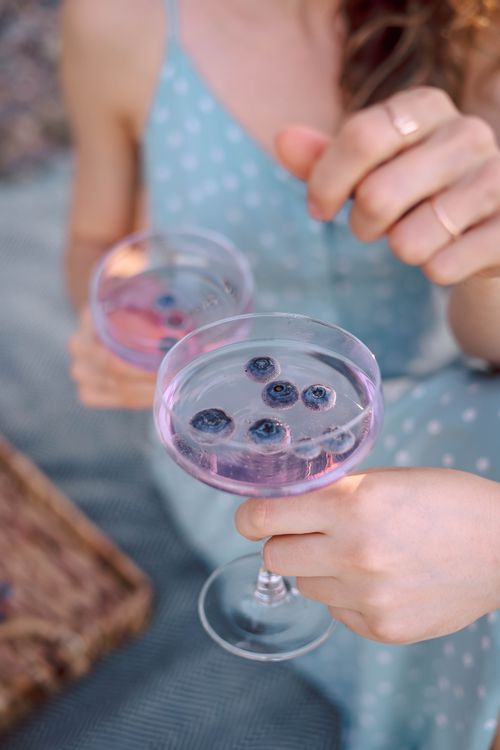 Free Two glasses of refreshing purple summer cocktail with blueberries outdoors. Perfect for relaxation. Stock Photo