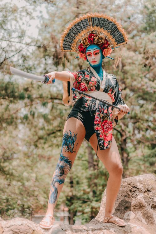 Free Colorful dancer in traditional costume with sword, showcasing cultural art in a dynamic outdoor setting. Stock Photo