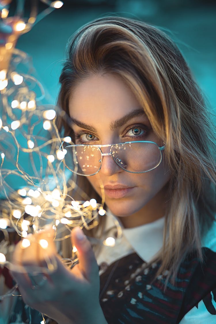 Close-up Photo Of Woman Holding String Lights