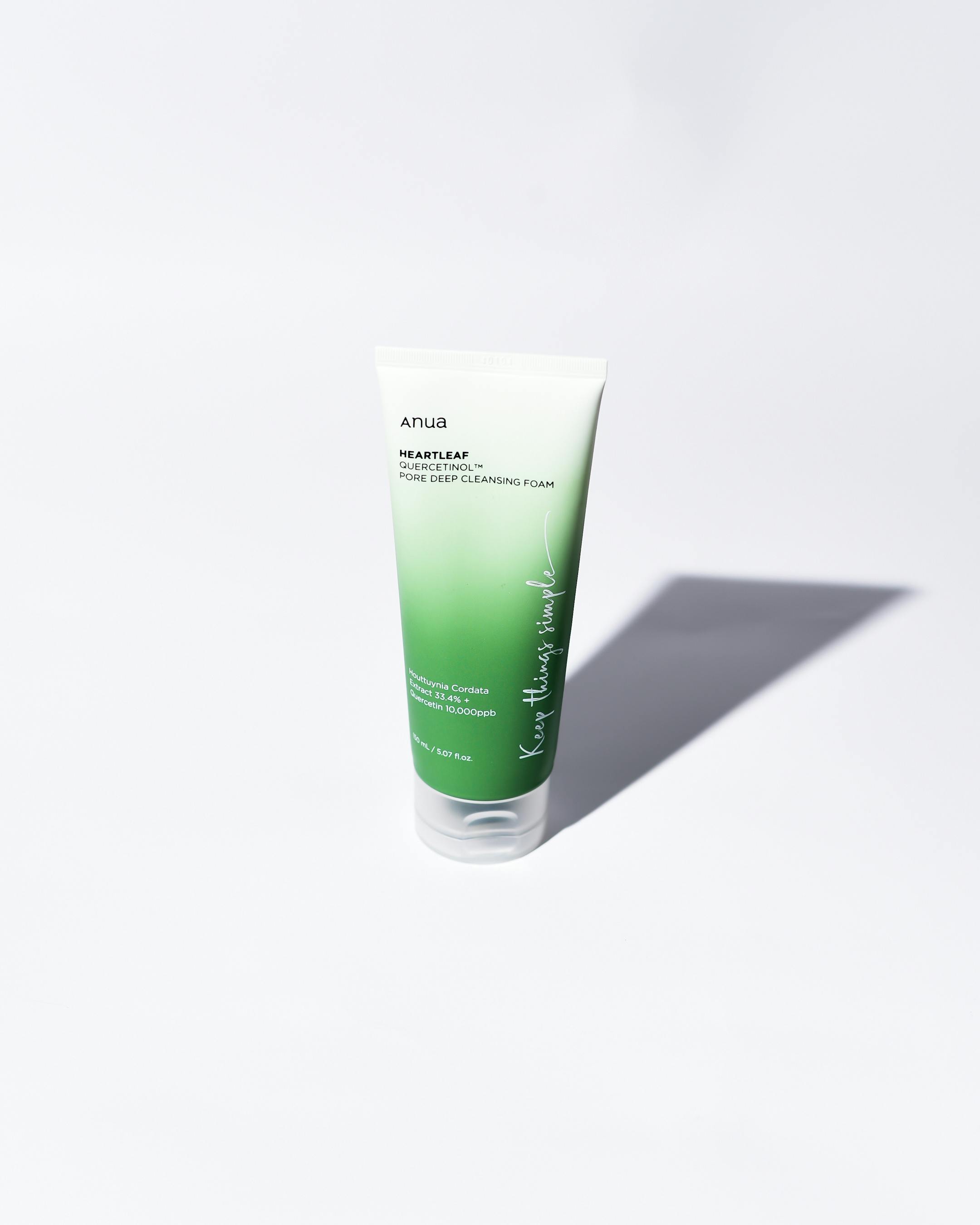 a tube of green body wash on a white surface