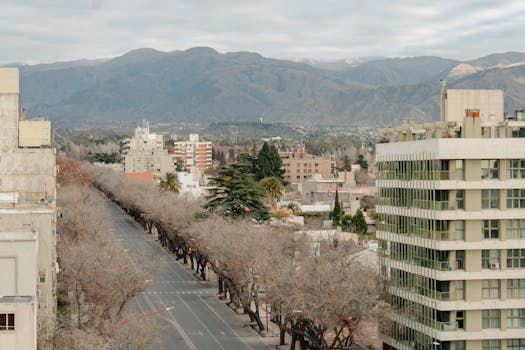 Aerial view of Mendoza, Argentina with mountains and modern buildings.