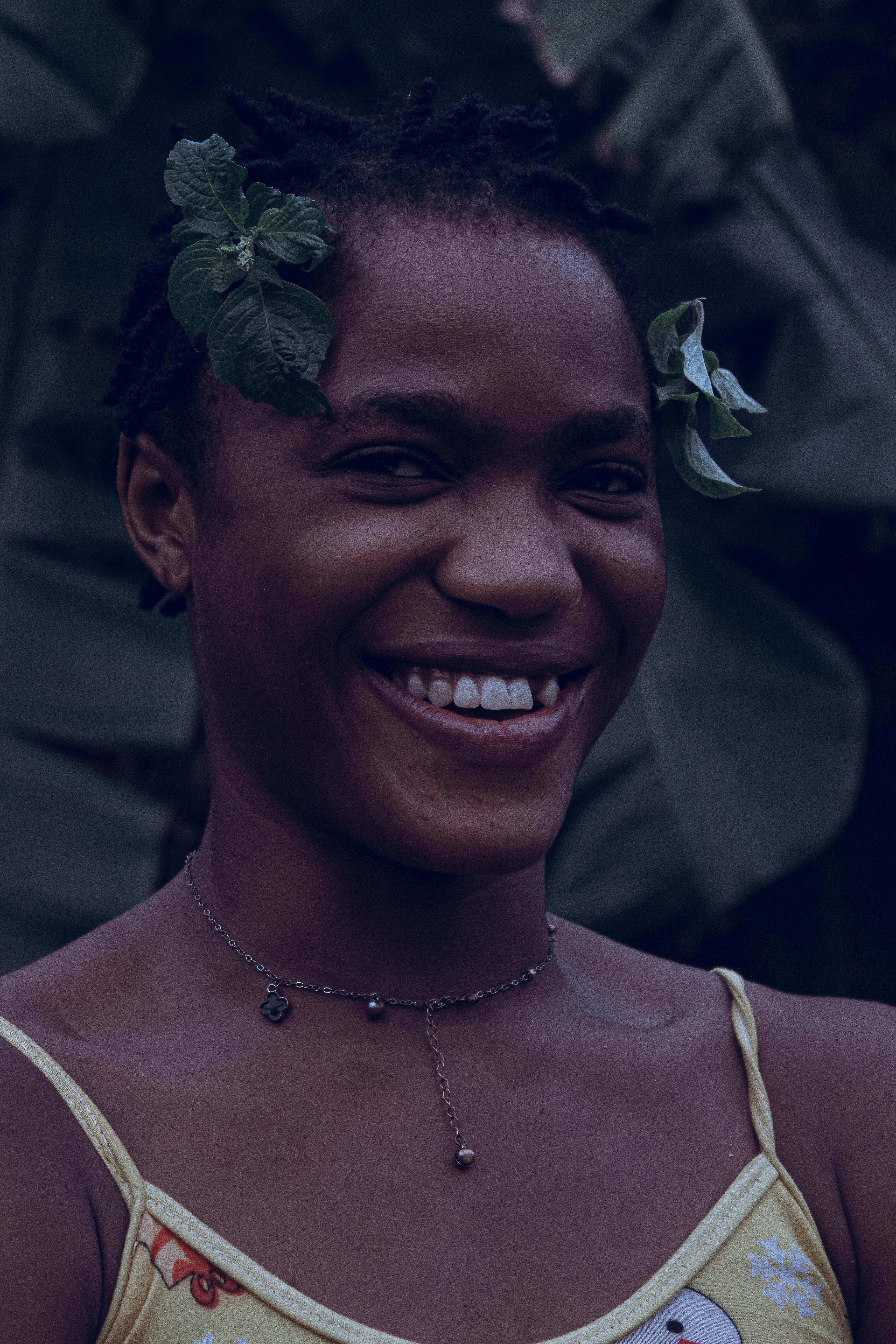 A smiling woman with flowers in her hair