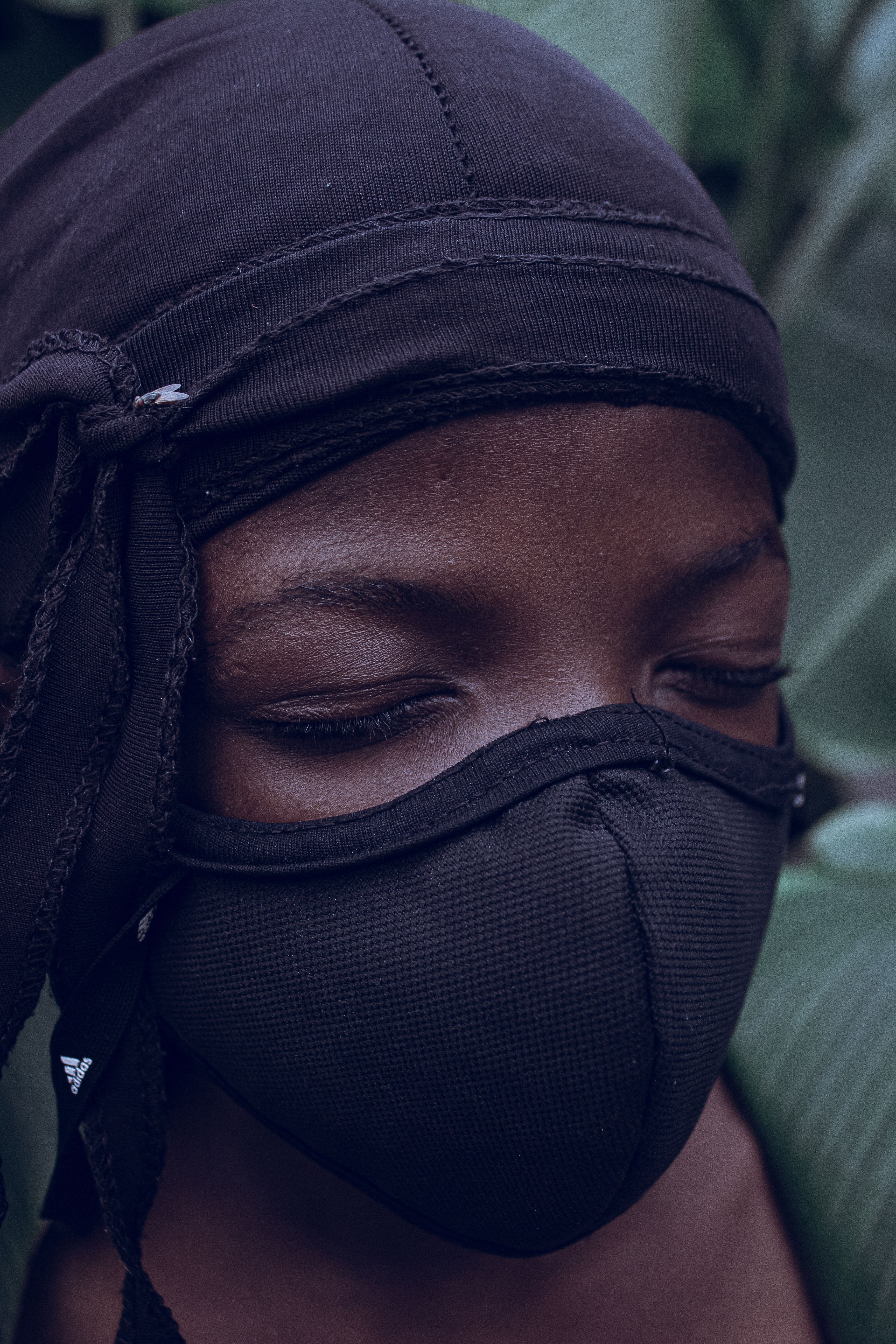 A woman wearing a black mask and a scarf · Free Stock Photo