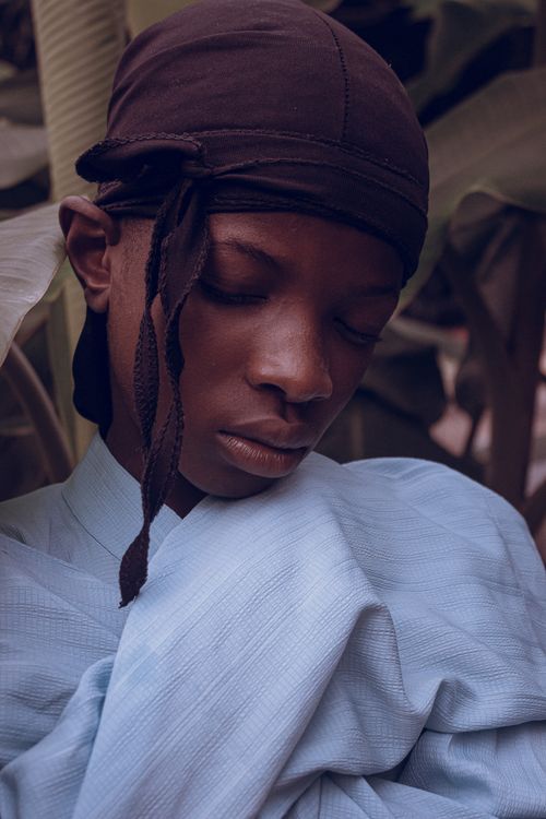 Free Peaceful moment captured as a young man in a headscarf rests outdoors. Stock Photo