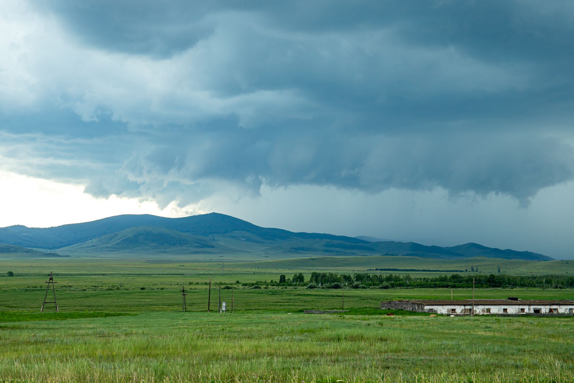 Dramatic storm clouds over expansive fields in Khakassia, Russia. Vast rural scenery.. dramatic, storm, clouds