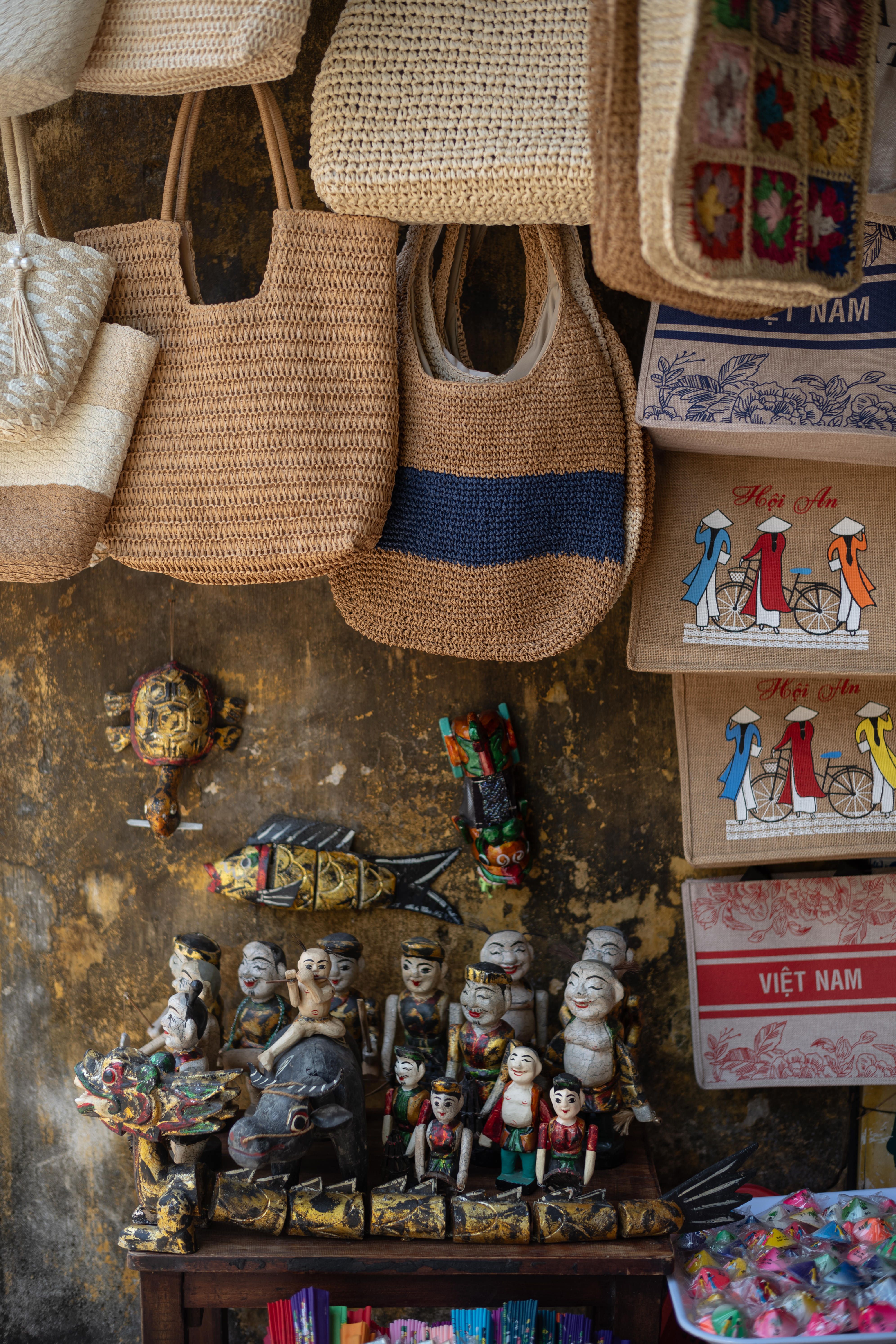 Explore a vibrant display of traditional Vietnamese handicrafts and souvenirs in Hội An's market.