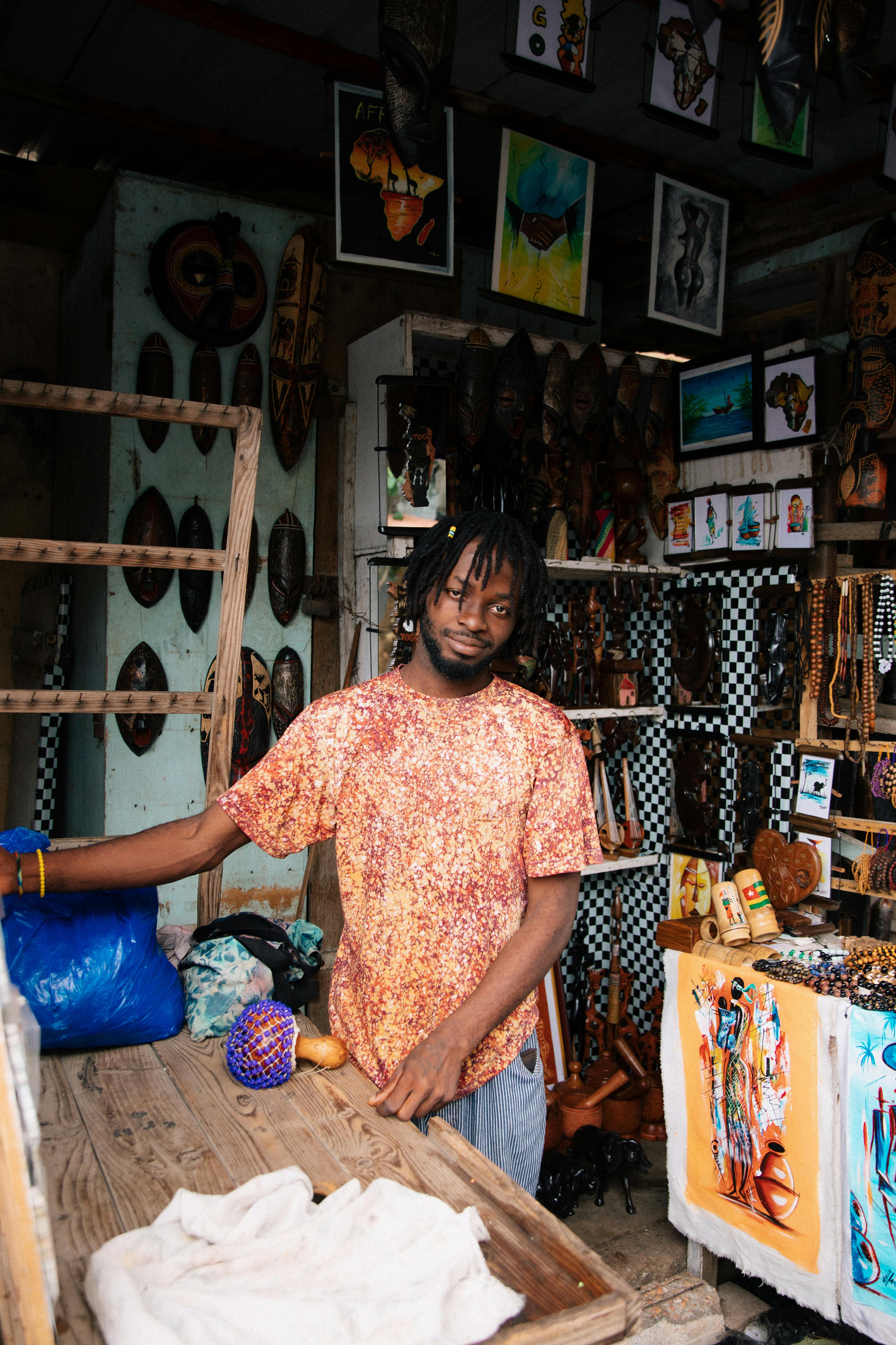 a man standing in front of a store with a variety of items