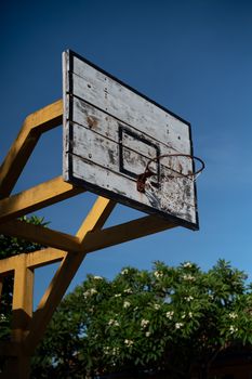 Rustic basketball hoop under a clear blue sky in Hội An, Vietnam. Perfect for travel or architecture themes.