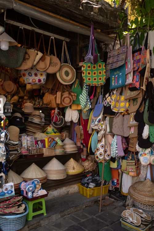 Free Explore a vibrant traditional market booth with handmade crafts in Hội An, Vietnam. Stock Photo
