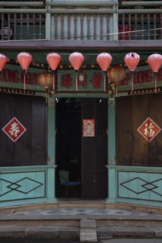 Explore the charm of a traditional Vietnamese building in Hoi An, adorned with red lanterns and intricate architecture.