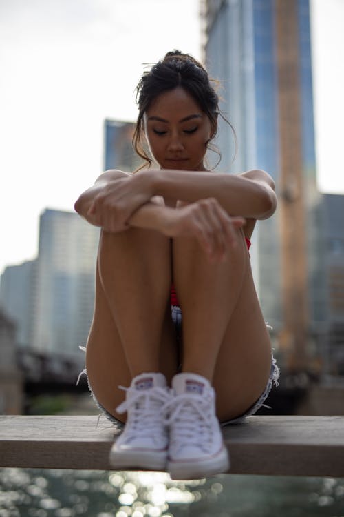 Woman Sitting on Wooden Bench